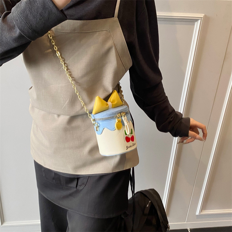 Bolso de cubo lindo japonés 2025 primavera y verano nuevo bolso femenino lindo lazo bolso de hombro mini cadena bolso de mensajero