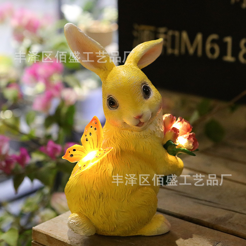Decoración de jardín transfronteriza abraza flores mariposas conejos adornos animales al aire libre lámpara solar artesanías de resina