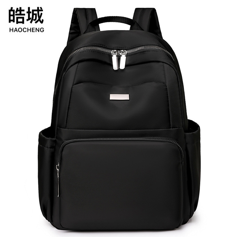 2024 verano nuevo estilo casual damas mochila de nailon simple y versátil mochila de computadora de gran capacidad para estudiantes al por mayor