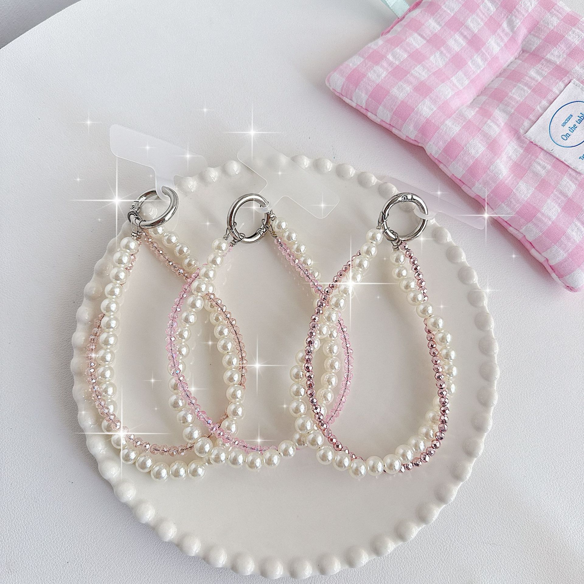 Boutique hecho a mano de alta gama teléfono móvil cadena colgante mujer estilo ins cristal coreano perla enrollamiento cadena de muñeca moda corta