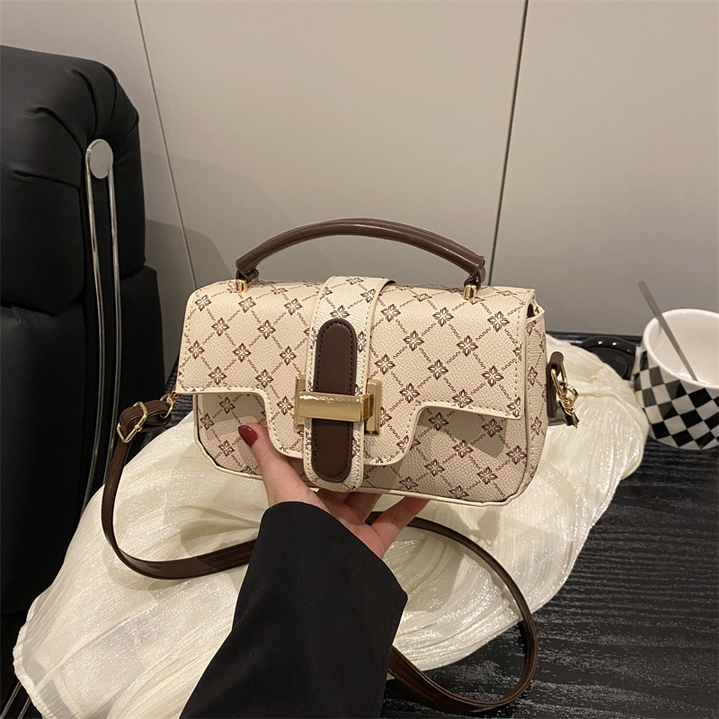 Bagos de color retro retro de estilo extranjero mujeres 2025 nuevo nicho diseño de empalme bolso pequeño bolso portátil de viaje