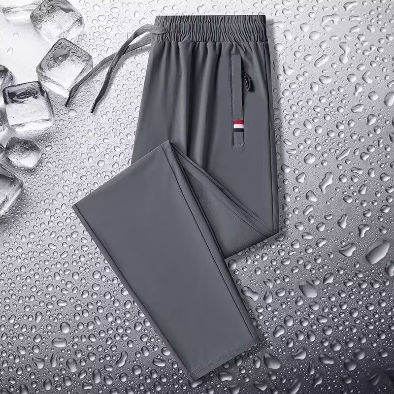 Camisas y menos ropa, pantalones de seda de hielo, pantalones de chándal elásticos finos de verano, pantalones rectos de hombre con cremallera de bolsillo al por mayor al por mayor