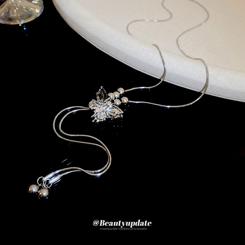 Serie de plata Collar de borla de cuentas de mariposa ajustable Cadena de clavícula de moda exquisita Cadena de suéter de diseño de lujo ligero Mujer