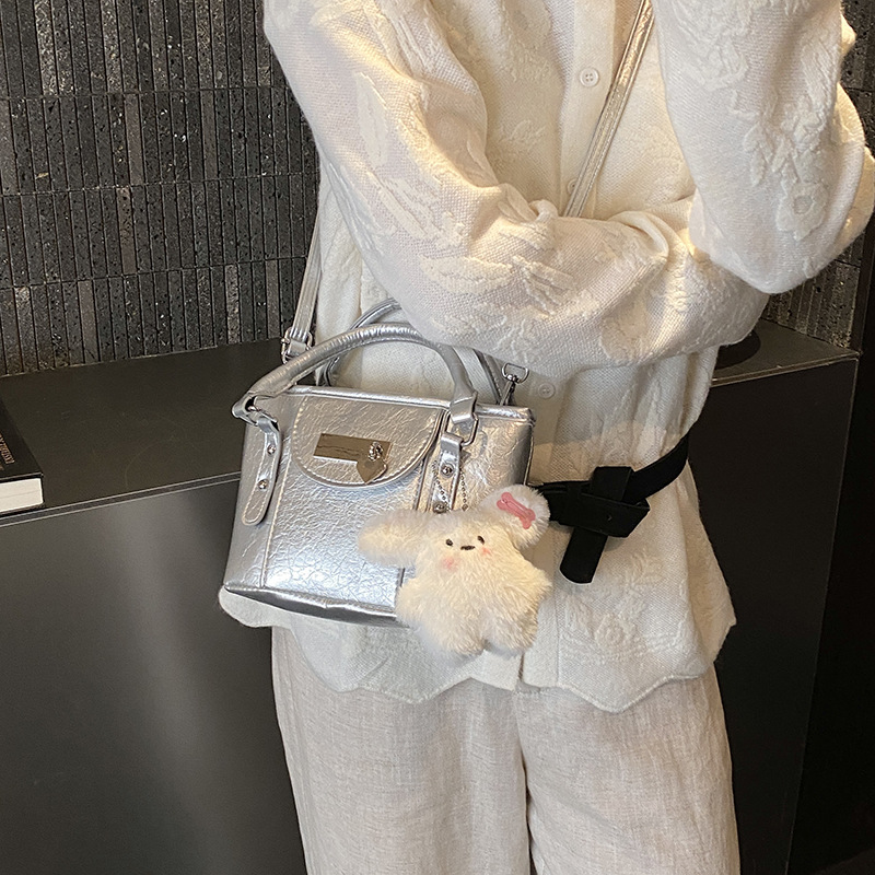 Nuevo bolso infantil transfronterizo simple bolso de bebé compacto color sólido lindo muñeca colgante bolso de cubo para hombres y mujeres