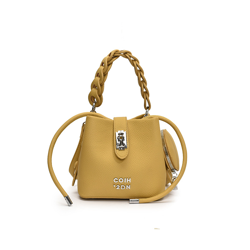 Bolso de mujer 2025 nuevo bolso de mensajero de hombro con patrón de lichi de alta calidad bolso de cubo portátil de moda casual de todo fósforo