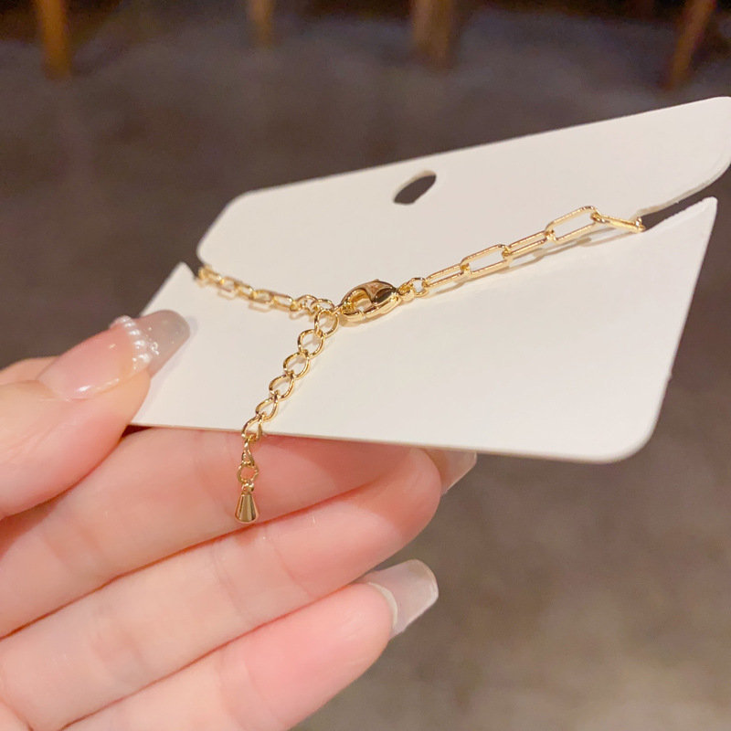 Pulseira elegante em pedra olho de gato com concha e estrela_voghion.com