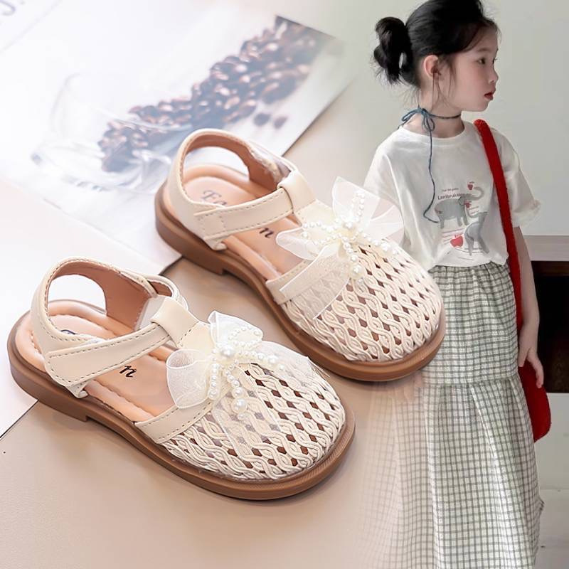 Sandalias para niñas 2025 verano nuevo estilo zapatos de princesa para niños niñas Baotou zapatos de playa sandalias tejidas con lazo de moda