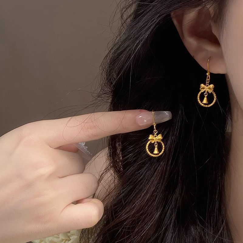 Princesa en fuga arco de oro campana pendientes ganchos de orejas dulces de alta calidad elegante temperamento orejas al por mayor