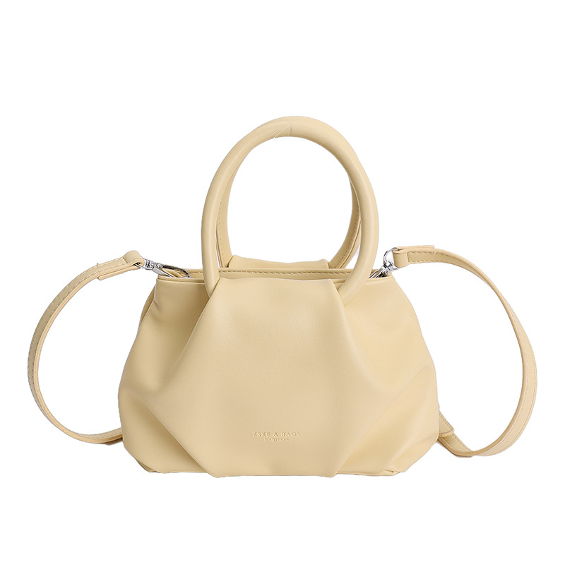 Alta sensación de mano pliegueada nube bolso de cubo para mujeres 2026 nuevo nicho de lujo ligero de moda perla bolsa de mochila