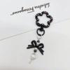 Black keychain with bow, flowered