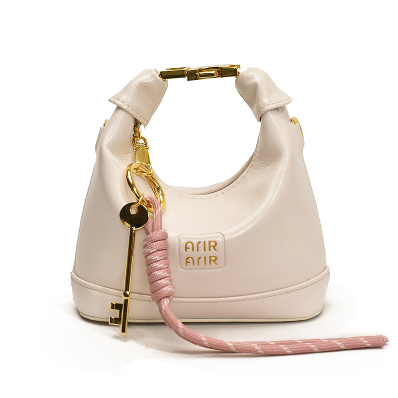 Bolso de hombro para niña coreana bolso de bebé con bloqueo de cuero de aceite de color sólido simple 2025 nuevo mini bolso para niños