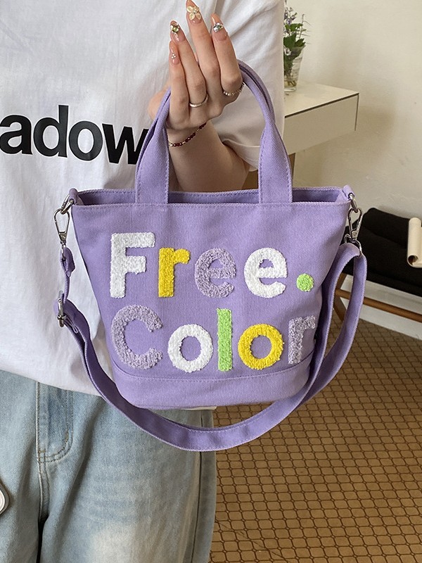 Mamá bolso para salir bolso de cubo de mano mujer 2026 nuevo bolso de lona bordado de dibujos animados letras casuales bolso de mochila