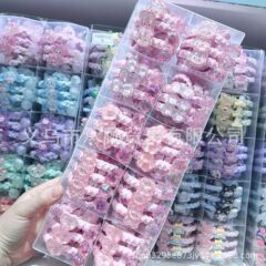 爆発的なピンクの氷の格子の蝶結びのウサギの愛の花の熊の高弾力の漫画の子供の髪の輪のひも
