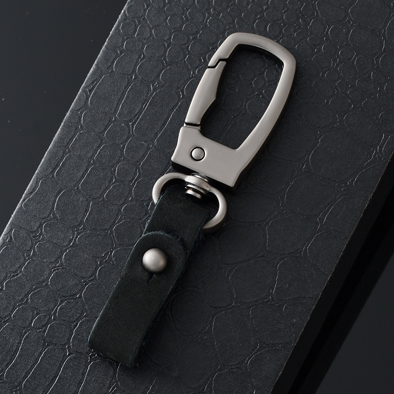 軽くて豪華な本革の自動車のキーホルダーの頭の層のつや消しの牛革の車のキーチェーンの個性のカップルの腰は掛けてペンダントをなくします。