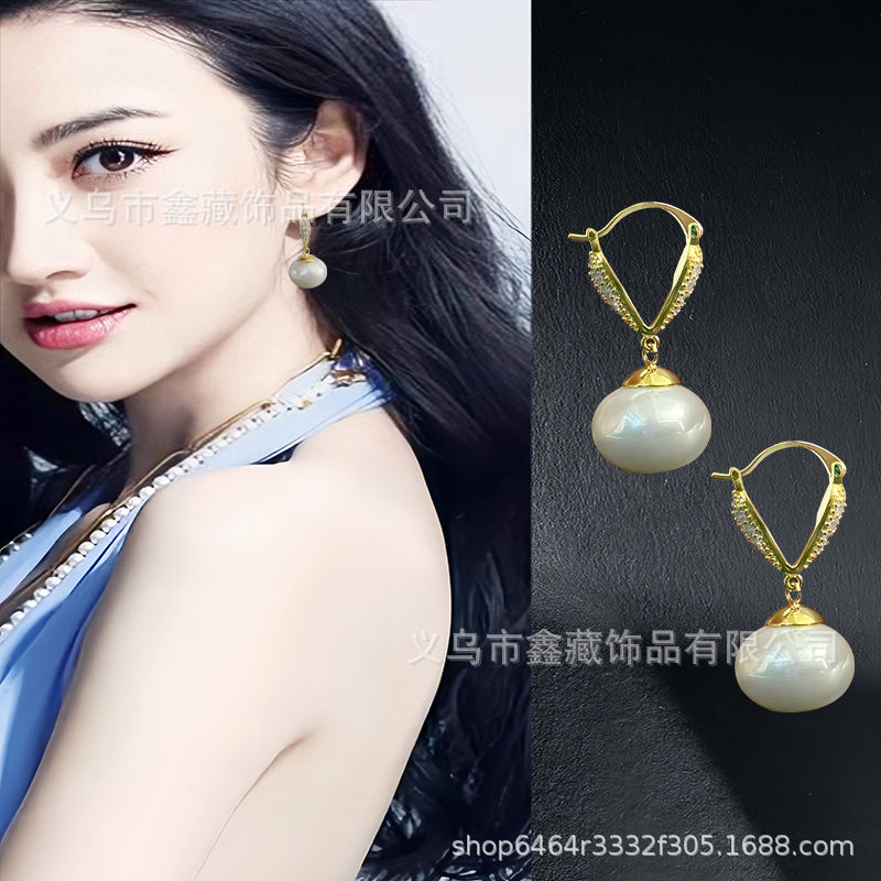 Fashionable elegant small design earrings from pearl with zircon