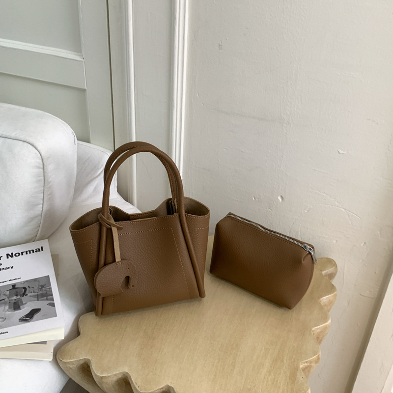 Bolso para mujeres 2026 nuevo estilo de moda bolso de cubo portátil de alta calidad lichi patrón popular lujo ligero mochila casual