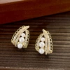 Golden earrings with zircon from pearl, lace dress
