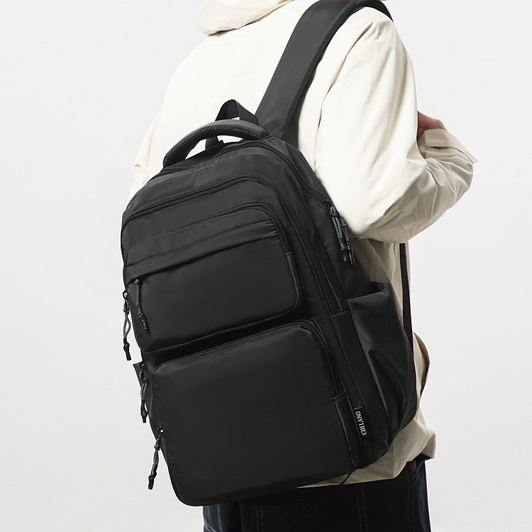 新款简约时尚大学生电脑背包多隔层大容量通勤轻便纯色双肩包