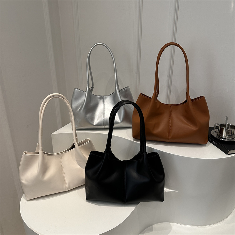 Este año, la sensación de relajación de la moda de color sólido 2024, el nuevo tipo de bolso de hombro simple de gran capacidad, bolso de mano de empalme de moda