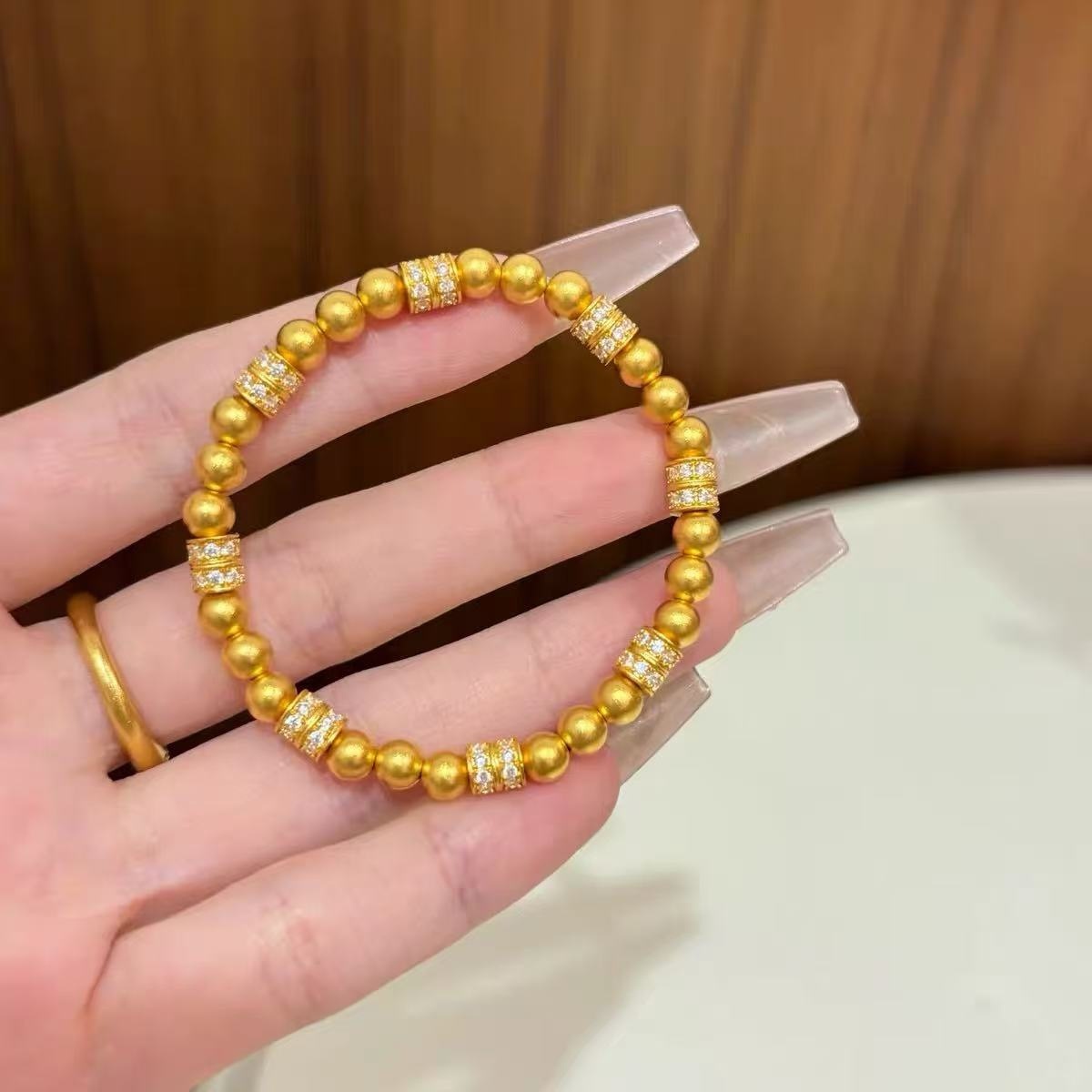 24K gold-plated, featuring real gold sand, simulated gold dots, and gold beads, this bracelet features a running ring design and is a new Chinese-style bracelet with solid gold beads