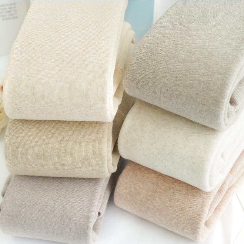 カシミヤの底のズボンの女性のベルベットの厚いズボンの靴下の春秋冬の系のオート麦の白い薄い色の縦の紋様の保温のズボンはやせています。