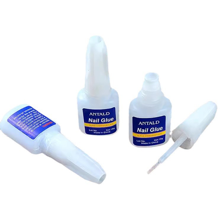 Pegamento de uñas al por mayor 10g botella azul con cabeza de cepillo pegamento de uñas adhesivo de secado rápido pegamento fuerte pegamento pegajoso pegamento de diamante protección del medio ambiente