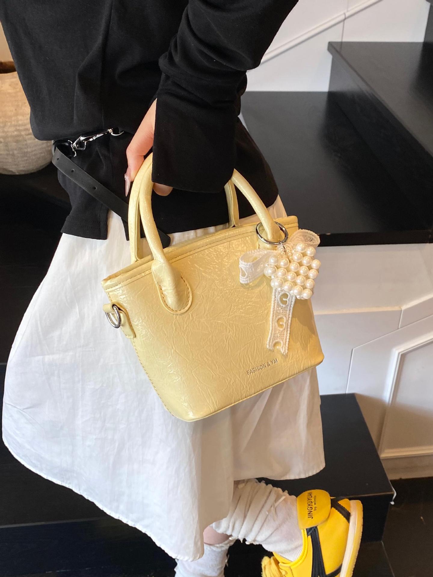 Bolso de cubo de mano súper caliente de comercio exterior 2025 nuevo bolso de hombro de tendencia salvaje de moda bolso de mensajero de nicho de alta gama de moda