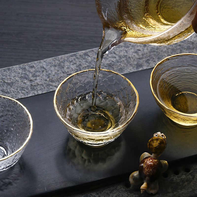 Patrón de martillo Xingran vidrio resistente al calor Taza de té de tres patas de oro juego de té de Kung Fu Propietario de una sola taza patrón de martillo de borde dorado taza de té pequeña