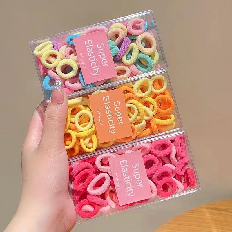 Asequible caja de almacenamiento de Corea del Sur de los niños pequeño tamaño cabeza cuerda bebé toalla anillo no duele pelo cabeza cuerda macaron pelo anillo