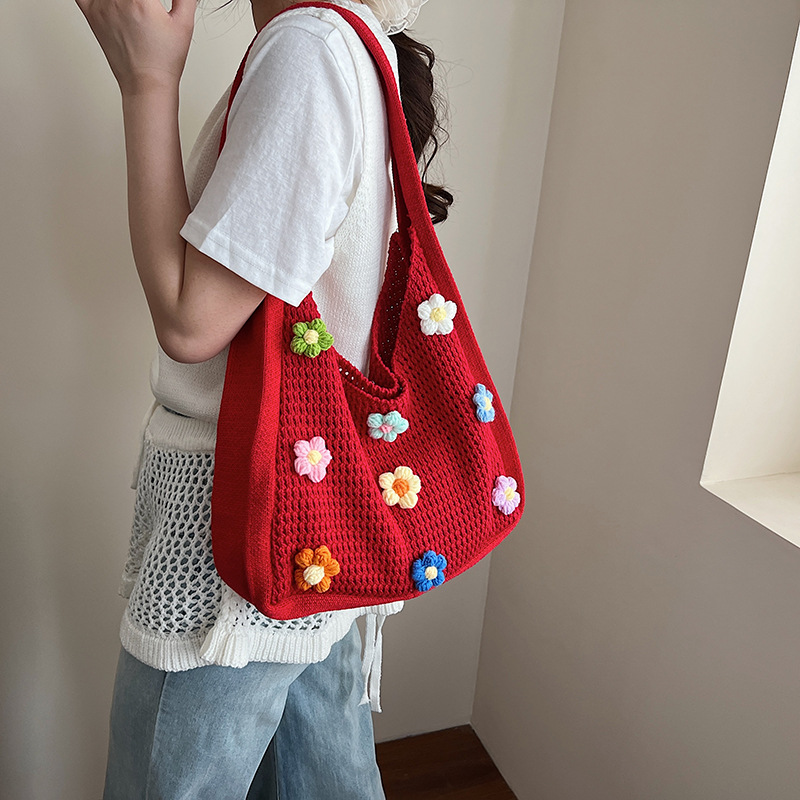 Versión coreana del bolso de nicho 2025 verano nuevo bolso femenino Xuan Yafeng flor bolso de hombro hueco de punto