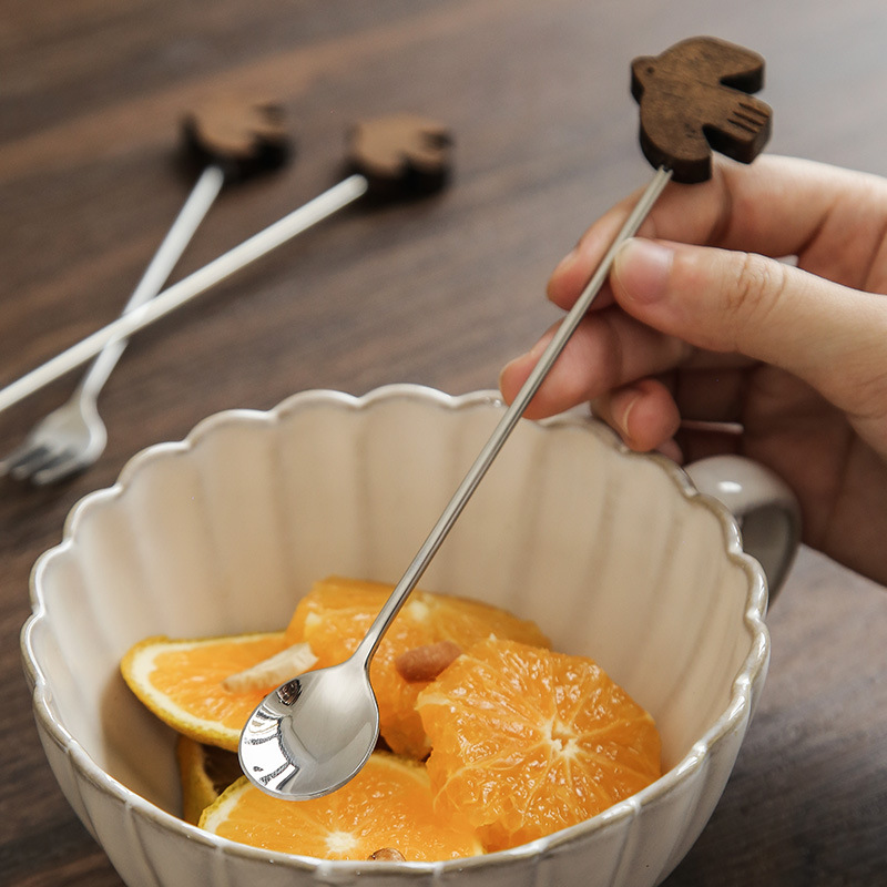 High-quality 304 stainless steel serving spoon with black walnut wood handle, designed for desserts, stirring, fruit spears, and coffee scoops. Wholesale available.