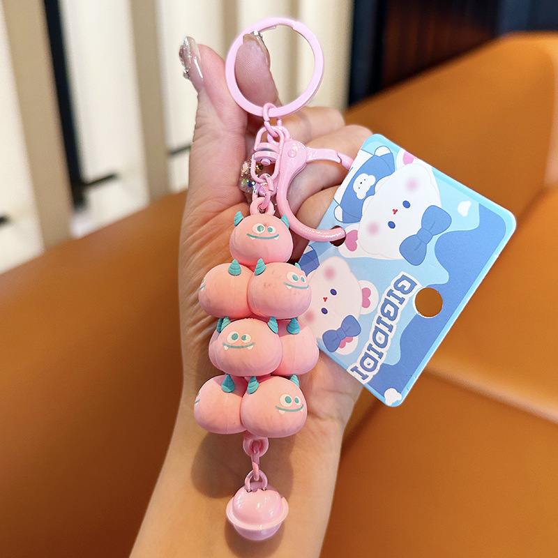 Popular en línea rojo creativo monstruo de dibujos animados jengle lindo mochila colgante coche llavero pareja pequeño regalo