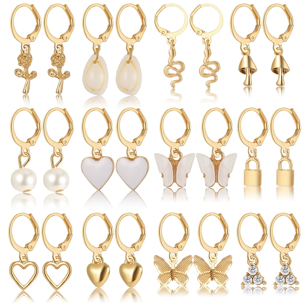Pearl earrings set, gold‑tone multi‑pair on display card, assorted charm styles