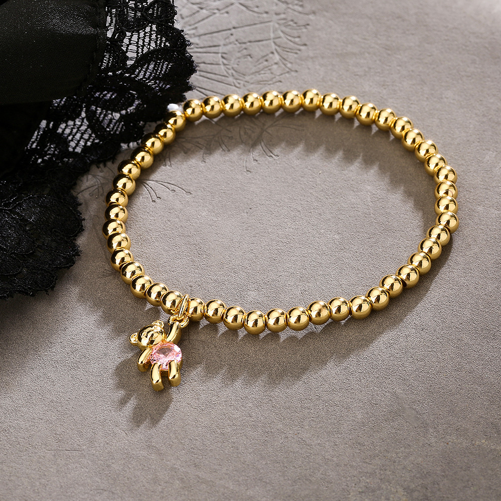 Bracciale con pendente orsetto e perline in rame e zircone donna_voghion.com