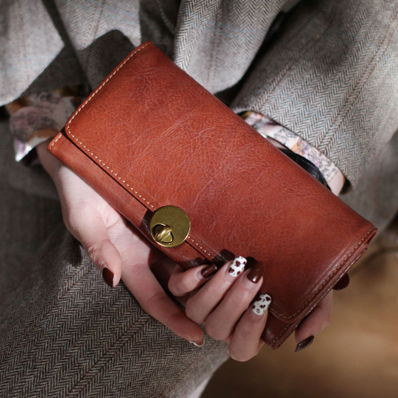 Cartera de cuero 2025 nueva billetera de mujer larga y delgada capa superior piel de vaca simple billetera de doble pliegue con cerradura retro europea y americana