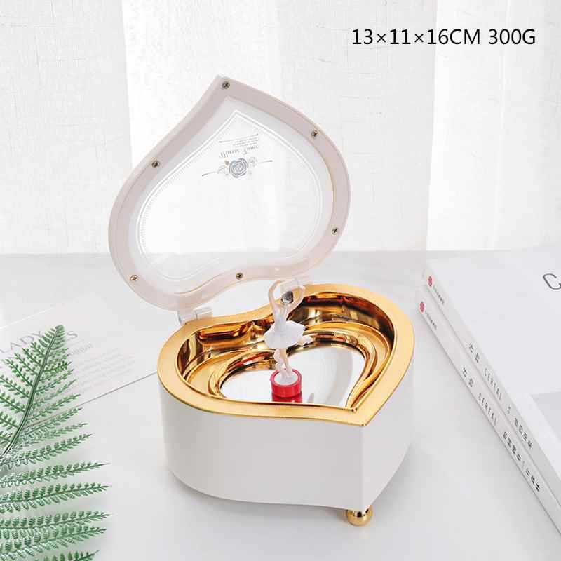 Caja de música blanca en forma de corazón con mecanismo de cuerda de bailarina