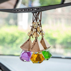 Car-mounted aromatherapy glass bottle with wooden lid, featuring beads and a small triangular design—perfect as an in-car pendant or air freshener.