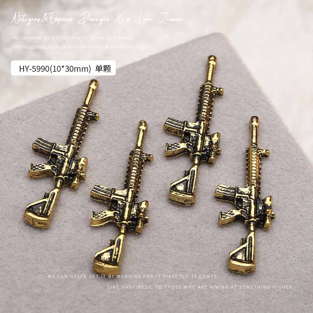 Europa y los Estados Unidos en línea con diamantes AK armas de manicuría joyas de simulación de personalidad tridimensional armas de fuego decoración de uñas al por mayor