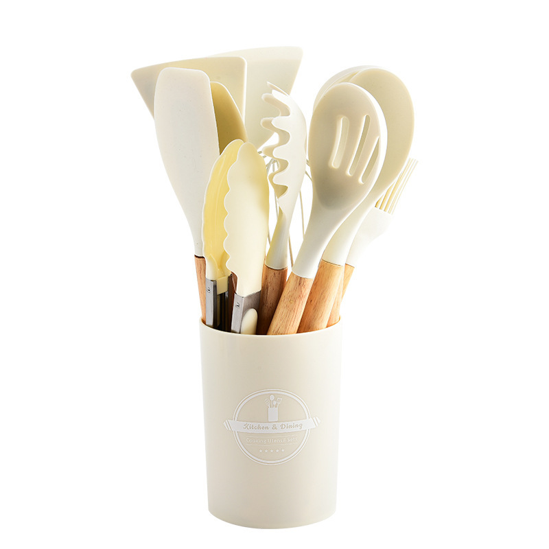 Juego de utensilios de cocina de silicona con mango de madera de doce piezas, de colores, para almacenar espátulas y cucharas resistentes a altas temperaturas y aptas para uso con alimentos, en stock.