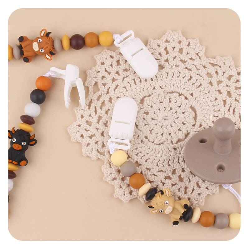 Productos infantiles de dibujos animados tridimensionales de vaca anti-caída cadena creativa bebé DIY silicona mordedor de goma molar calmar la cadena de tetina