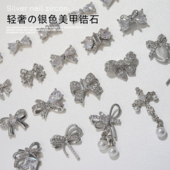 ジルコンのネイルアクセサリーの蝶結びのネイルドリルの合金の真珠のネイルドリルの赤い本の部品は卸売りを飾ります。