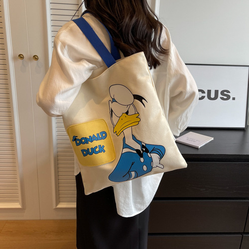 Original niche canvas bag for women, new cartoon Donald Duck hand-held tote bag for college students, reading single-shoulder cross-border