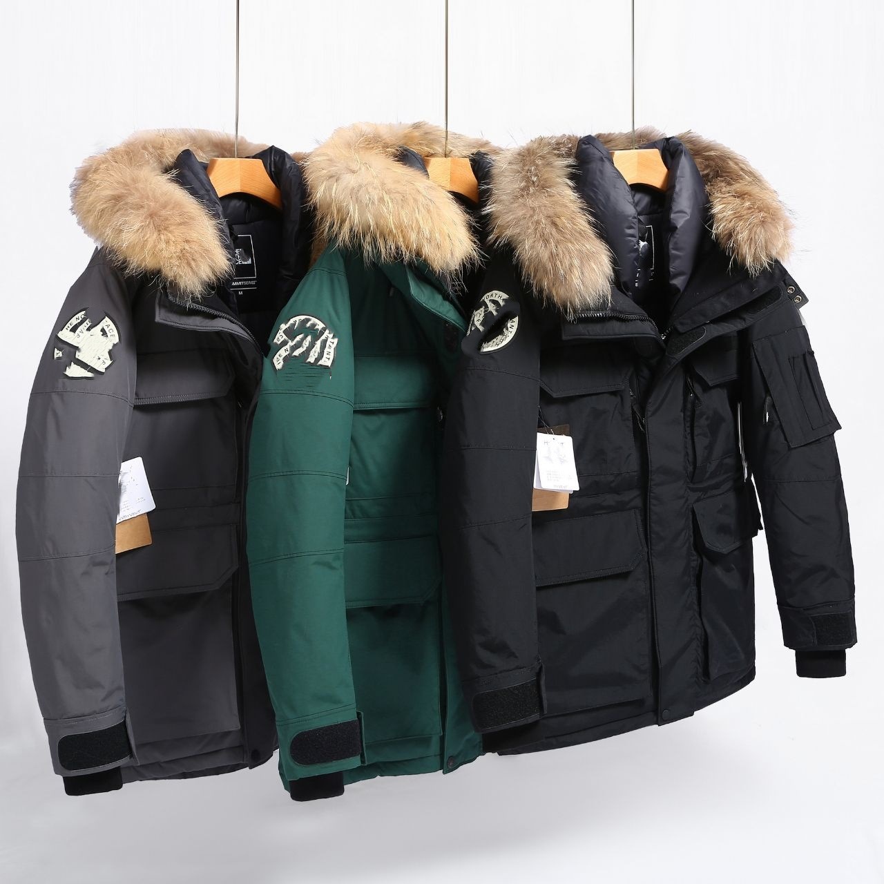 High-quality, trendy brand collaboration series: oversized workwear-style parka with a large faux fur collar, filled with 80% white duck down, and featuring a hood