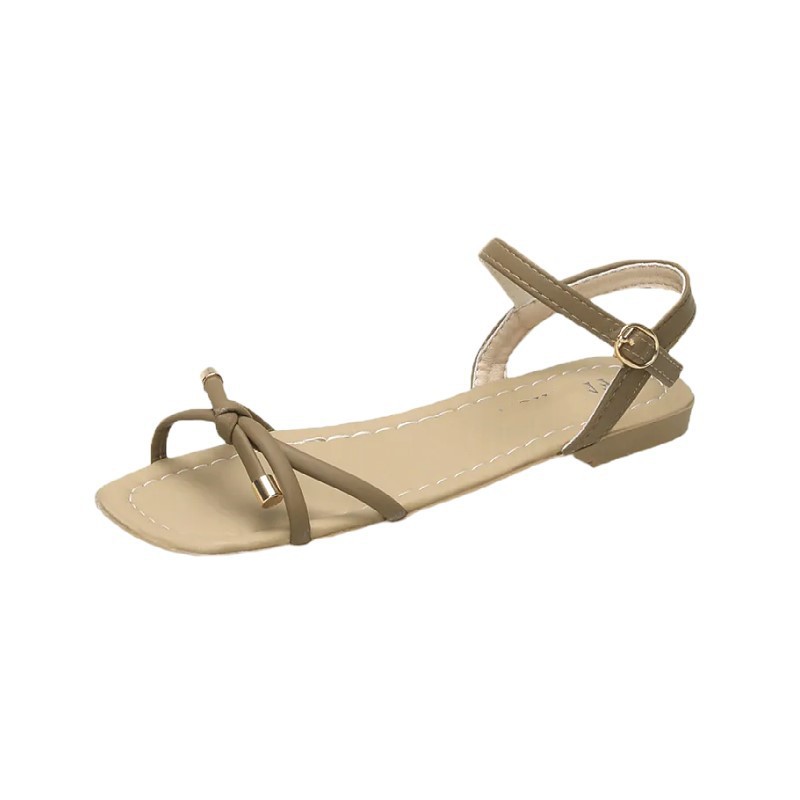 Arco sandalias planas para mujeres verano 2026 nuevo estilo con una sola línea suave de hadas estilo versátil no cansado zapatos de viaje