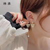 Small asymmetrical design long demi-season earrings with tassels, simple and elegant design