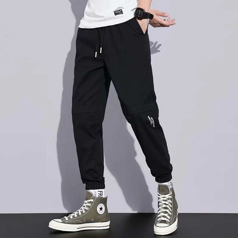 Pantalones de estilo de Hong Kong pantalones casuales de los hombres de estilo japonés de color sólido sueltos monos atados a los tobillos pantalones casuales de los hombres de la marca de moda Pantalones a juego