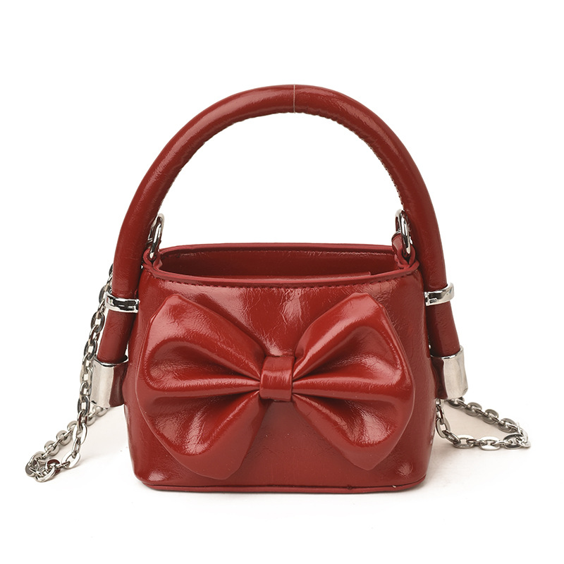 Nuevos bolsos de cadena coreanos para niños y niñas, bolsos de mini arco, bolsos de mano para niños, bolsos de comercio exterior transfronterizos