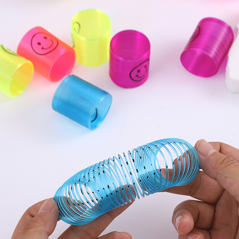 Nuevo 3.2 * 3.5cm sonriente transparente pequeño arco iris bobina de plástico para niños juguetes plegables