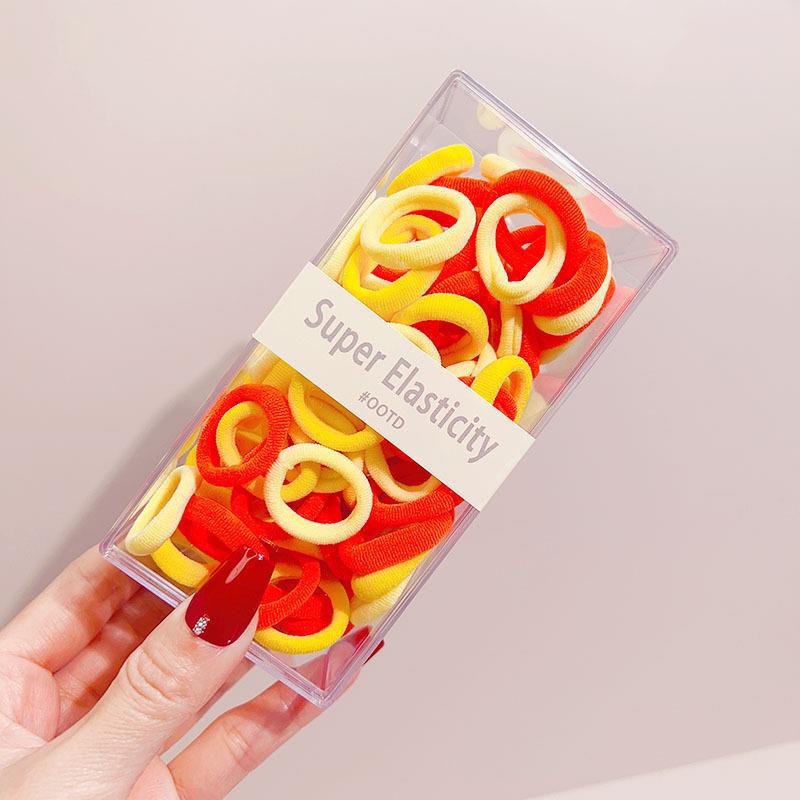 Asequible caja de almacenamiento de Corea del Sur de los niños pequeño tamaño cabeza cuerda bebé toalla anillo no duele pelo cabeza cuerda macaron pelo anillo