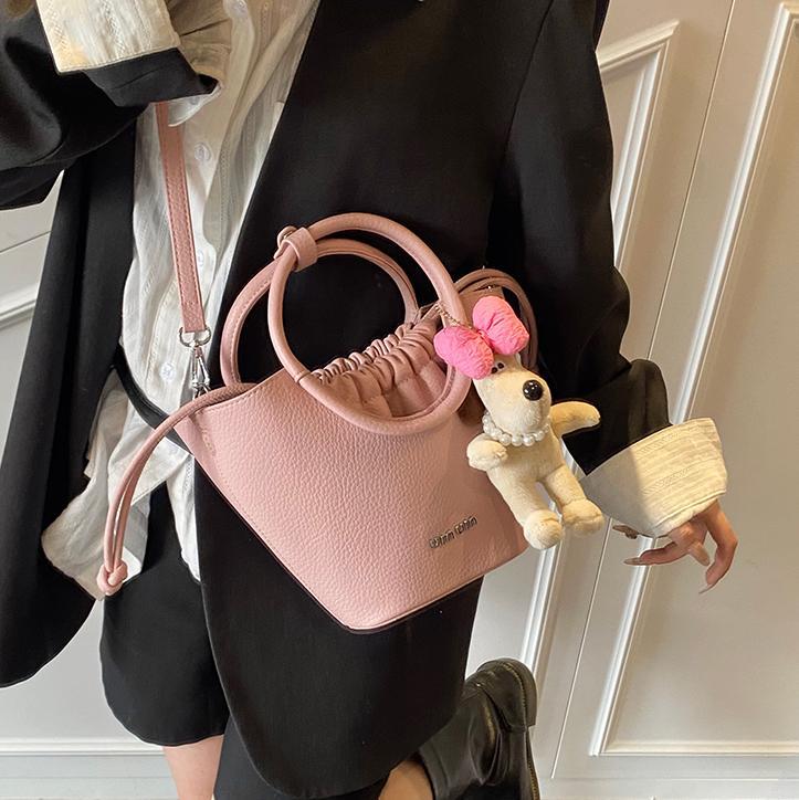 Bolsos de mano de nicho de tendencia transfronteriza para damas 2025 nuevo bolso de hombro simple de moda con textura bolso de cubo de todo fósforo